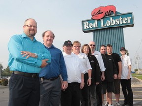 Mike Talpas, general manager of the Red Lobster restaurant, left, stands with some staff,  Jeff Tazzman, Jeff Wheeler, Carrie MacMillan, Debbie Henwood,  Steve Turner, Mark Phillips, Mike Boulay and Jodi Bisutti at the Tecumseh Road location.  (JASON KRYK / The Windsor Star)