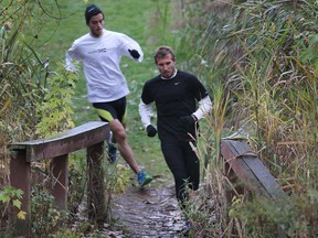 Nick Falk, right, and Michael of the Lancers cross-country team train Monday at the Malden Park in preparation for the CIS championships. (DAN JANISSE/The Windsor Star)