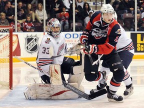 Windsor's Kerby Rychel, right, chases a loose puck in front of Generals goalie Daniel Altshuller during OHL action at the General Motors Centre in Oshawa Sunday, November 17, 2013. The Spitfires won 4-1. (Ryan Pfeiffer/Durham News)