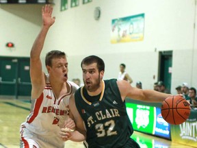 St. Clair's Alex Temesy, right, drives to the basket against Redeemer's Calvin DeJong during OCAA basketball action at St. Clair College, Saturday, Nov. 2, 2013. (DAX MELMER/ The Windsor Star)