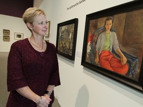 Catharine Mastin, Art Gallery of Windsor executive director, admires a painting by Ken Saltmarche at the AGW. The works, which are part of the Saltmarche estate, are being auctioned off as part of a joint fundraiser between the Saltmarche family and the AGW. (TYLER BROWNBRIDGE / The Windsor Star)