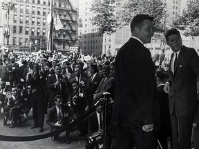 Windsor photographer Spike Bell, shown kneeling with his camera, bottom left, poised to take a photograph of Michigan Governor John Swainson and John F. Kennedy in Detroit circa 1962. (FILES/The Windsor Star)