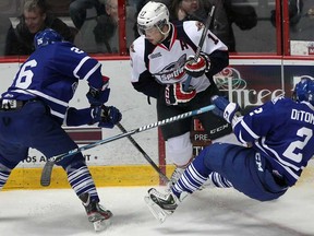 Windsor's Steven Janes, centre. knocks over Mississauga's Greg DiTomaso, right, and battles with Brett Foy, left, during OHL action at the WFCU Thursday November 14, 2013. (NICK BRANCACCIO/The Windsor Star)