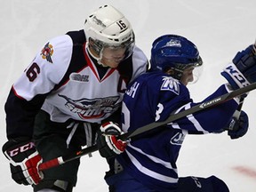 Windsor's Kerby Rychel, left, slows down Mississauga's Jared Walsh during OHL action at the WFCU Thursday November 14, 2013. (NICK BRANCACCIO/The Windsor Star)