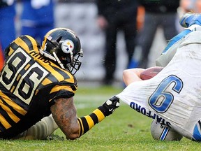 Detroit QB Matthew Stafford, right, is sacked by Pittsburgh's Ziggy Hood during the fourth quarter on November 17, 2013 in Pittsburgh. (Joe Sargent/Getty Images)