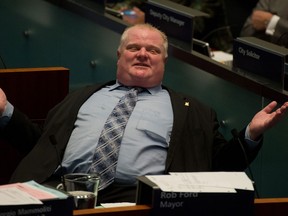 Toronto mayor Rob Ford reacts at City Hall in Toronto, Ontario, November 13, 2013. Council was in session today debating a motion put forth by council to appeal to the provincial government to have the mayor removed from office.  (Tyler Anderson/Postmedia News)