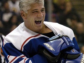 Former Leafs captain Rick Vaive, left, laughs during the Hockey 2004 Legends Classic in Toronto Saturday Nov. 6, 2004. Vaive is among 10 ex-NHLers invovled in a a class-action lawsuit claiming that the league hasn't done enough to protect players from concussions. (THE CANADIAN PRESS/Aaron Harris)