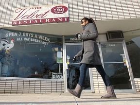 A pedestrian walks by the Velvet Restaurant in Windsor  on Fri. Nov. 29, 2013.  The 90-year-old business is closing Dec. 4th.  (DAN JANISSE/The Windsor Star)