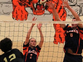 Sandwich's Sabrina Safranyos, left, and Nathan Hesman, right, try to block Riverside's Marcus Duben during a WECSSAA boys volleyball semifinal at Sandwich gym Tuesday November 5 , 2013. (NICK BRANCACCIO/The Windsor Star)