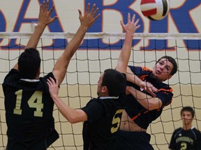 Riverside's Marko Janjetovoic, left, and Jacob Tohan, centre, try to block Sandwich's Nathan Hesman in a WERCSSAA volleyball semifinal in LaSalle Tuesday November 5 , 2013. (NICK BRANCACCIO/The Windsor Star)