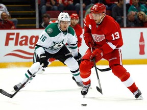 Detroit centre Pavel Datsyuk, right, carries the puck against Dallas winger Ryan Garbutt in Detroit Thursday, Nov. 7, 2013. (AP Photo/Paul Sancya)