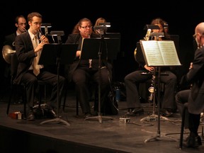 Oboists Graham Mackenzie, front left, and Faith Scholfield and principal clarinetist James Ormston (back to camera) perform with the Windsor Symphony Orchestra during the opening concert of WSO Intimate Classics series at Capitol Theatre on Friday. (DAX MELMER /  The Windsor Star)