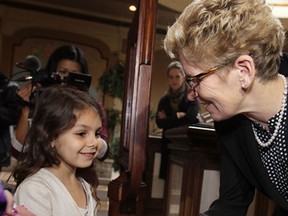 Ontario Premier Kathleen Wynne meets Gabby Wilkinson, 7, Fri. Nov. 22, 2013, before a luncheon in Windsor, Ont. The young Amherstburg girl sold the Premier a handmade bracelet which she makes to raise money for charity. (DAN JANISSE/The Windsor Star)
