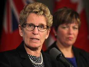 In this file photo, Ontario Premier Kathleen Wynne, left, speaks to media Friday, Nov. 22, 2013, after a luncheon sponsored by the Windsor-Essex Regional Chamber of Commerce as MPP Teresa Piruzza looks on. (DAN JANISSE/The Windsor Star)