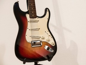 The Fender Stratocaster electric guitar played by Bob Dylan on July 25, 1965 at the Newport Folk Festival, better known as "the night Dyan went electric" is seen at an auction preview at Christie's on November 25, 2013 in New York City. The guitar was expected to sell for $500,000, but fetched $800,000.  (Photo by Andrew Burton/Getty Images)