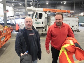 Enwin Utilities supervisor, Ron Skill, left, and lead lineman Adrian Viselli talk about their experience helping to restore power to the Toronto area following last week's ice storm. A crew from Windsor just returned. (JASON KRYK/The Windsor Star)