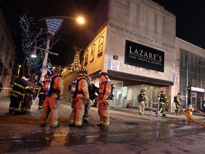 Firefighters battle a blaze at the former Lazare's Furs in Windsor on Monday, Dec. 30, 2013. The fire broke out just before 6 p.m. and was contained to the interior of the building.                       (TYLER BROWNBRIDGE/The Windsor Star)