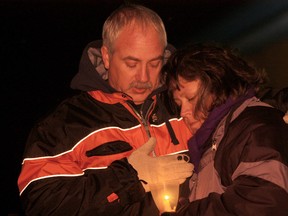 Guy and Debbie Leveille hold a candle in remembrance of their son, Jesse Lee, at the Safety Village for the Compassionate Friends Worldwide Candle Lighting Saturday, Dec. 8, 2013. (JOEL BOYCE/The Windsor Star)