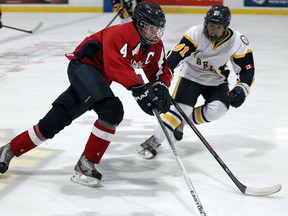 Windsor Junior Spitfires Max Sieberer, left, goes wide on LaSalle Sabres Gianluca Geloso in the first period of the bantam minor championship game of the Riverside Hockey Tournament at the WFCU Centre on Monday, Dec. 30, 2013.  (NICK BRANCACCIO/The Windsor Star)
