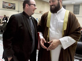 Rev. Kevin George, left, and Imam Shikh Mohamed Mahmoud share a laugh before a Christian-Muslim symposium held at Windsor Mosque on Sunday, Dec. 15, 2013. (REBECCA WRIGHT/ The Windsor Star)
