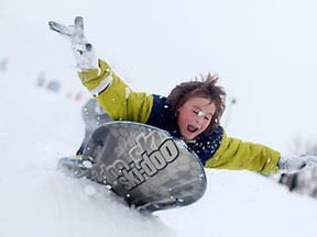 Curtis Stevenson, 10, flies over a jump while sledding down suicide hill at Riverside Kiwanis Park after an overnight snowstorm, Sunday, Dec. 15, 2013.  (DAX MELMER/The Windsor Star)