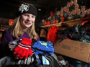 Tatum Roy, 11, who donated about 400 winter accessories to the Hiatus House and Street Help/Unit 7, is pictured at Street Help/Unit 7 with some of the items she donated, Sunday, Dec. 8, 2013.  (DAX MELMER/The Windsor Star)