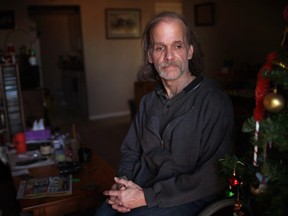 Steve Reh, 50, a former resident of Southwestern Regional Centre from the age of seven to 17, looks out the window of his high-rise apartment in Windsor, Saturday, Dec. 28, 2013. Reh is one of at least eight plaintiffs from the Windsor area involved in a class-action lawsuit against the province for alleged mental and physical abuse.  (DAX MELMER/The Windsor Star)