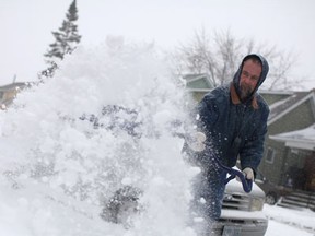 Dave Grieve shovels snow on the 1400 block of Moy after an overnight snowstorm, Saturday, Dec. 14, 2013. (DAX MELMER/The Windsor Star)