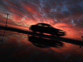 A car heads north on Walker Road near Paquette Corners under a brilliant sunset, Friday, Dec. 27, 2013.   (DAX MELMER/The Windsor Star)