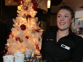 Christmas Day worker Jessica Tilley, 19, was in good spirits Christmas morning at Grill 55 on Huron Church Road December 25,  2013.  (NICK BRANCACCIO/The Windsor Star)