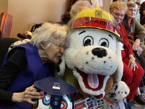 Files: Nellie Paley, 95, gives Sparky a kiss and a hug after Windsor firefighters collected an "unbelievable amount" of new, unwrapped toys from residents and staff at Chartwell Oak Park Terrace on North Service Road, Tuesday December 10, 2013.  Toys for Sparky's Toy Drive are earmarked for needy families during the holidays.  (NICK BRANCACCIO/The Windsor Star)