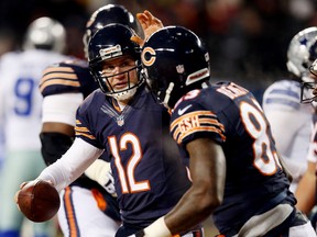 Chicago quarterback Josh McCown, left, celebrates a second-quarter touchdown with tight end Martellus Bennett against the Dallas Cowboys Monday at Soldier Field. (Photo by Jonathan Daniel/Getty Images)