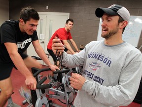 Spitfires athletic therapist Joey Garland, right, works with Brady Vail, left, and Austin Brassard last year.   (NICK BRANCACCIO/The Windsor Star)