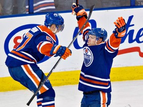Former Spitfire Taylor Hall, right, celebrates with David Perron after Hall scored the tying goal against the Calgary Flames Saturday. (THE CANADIAN PRESS/Jason Franson)