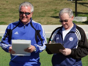 University of Windsor soccer coaches Steve Hart, left, and Pat McNellis record times during a practice in 2006. (NICK BRANCACCIO/The Windsor Star)