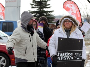 Striking Red Cross Care Partners (RCCP) including chief steward Millie Hickson, right, on the picket line during a noon hour rally on Grand Marais Road East  December 11, 2013.  Other unions joined picketers and showed their support. (NICK BRANCACCIO/The Windsor Star)