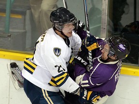 The University of Windsor's Drew Palmer, left, checks Western's Steve Reese. (TYLER BROWNBRIDGE/The Windsor Star)