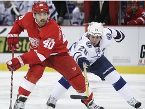 Detroit's Henrik Zetterberg, left, is checked by Tampa Bay's Martin St. Louis. (DAX MELMER/The Windsor Star)