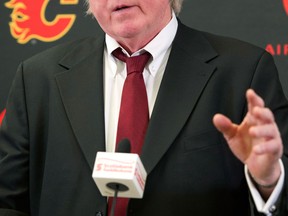 Calgary's president of hockey operations Brian Burke announces the firing of GM Jay Feaster and assistant GM John Weisbrod. (THE CANADIAN PRESS/Larry MacDougal)