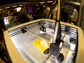 A  3 D printer is displayed   in the " 3 D Print Show"exhibition in Paris on November 15, 2013. AFP PHOTO /JOEL SAGET