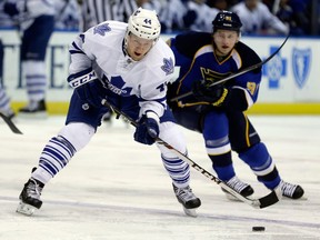 Toronto's Morgan Rielly, left, is checked by Vladimir Tarasenko of the Blues Thursday in St. Louis. (AP Photo/Jeff Roberson)