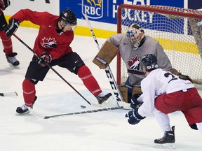 Tecumseh's Kerby Rychel, left, is  stopped by CIS Toronto Selects goalie Garrett Sheehan, centre, as CIS defenceman Lane Werbowski, right, looks on during exhibition action at the world Juniors selection camp in Toronto Saturday, (THE CANADIAN PRESS/Nathan Denette)