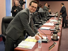 Newly-elected Ward 7 councillor Irek Kusmierczyk gets to his chair at city council just before a swearing-in ceremony  Monday  December 16, 2013. (NICK BRANCACCIO/The Windsor Star)