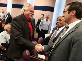 MPP Percy Hatfield, left, is greeted by newly-elected Ward 7 councillor Irek Kusmierczyk, right, and councillor Ron Jones at council meeting Monday  December 16, 2013. (NICK BRANCACCIO/The Windsor Star)