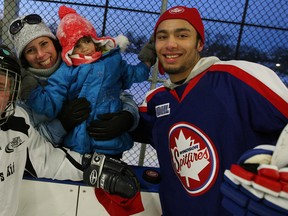 Knobby's Kid Will Giberson, left, is joined by his mother Kim Giberson and sister Maddie Giberson and Windsor Spitfires forward Josh Ho-Sang at Lanspeary Park for a free skate Monday. (NICK BRANCACCIO/The Windsor Star)