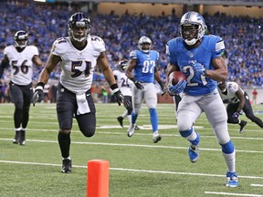 Detroit's Reggie Bush, right, runs 14 yards for a touchdown during the first quarter against the Baltimore Ravens at Ford Field Monday. (Photo by Leon Halip/Getty Images)