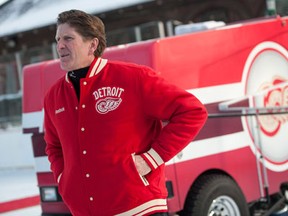 Red Wings coach Mike Babcock waits on the rink near the newly donated Zamboni during an event at Clark Park in Detroit Monday. (AP Photo/The Detroit News, David Guralnick)