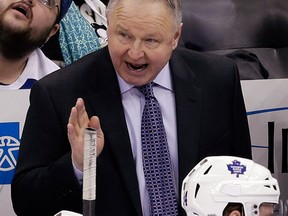 Toronto Maple Leafs head coach Randy Carlyle, top, gives instructions against the Pittsburgh Penguins in Pittsburgh Monday. (AP Photo/Gene J. Puskar)