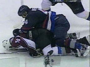 Windsor's Steve Moore, left, is attacked by Todd Bertuzzi of the Canucks in 2004. (Courtesy of Sportsnet).