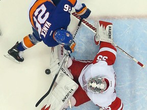 Detroit goalie Jimmy Howard, right, makes a save on New York's Thomas Vanek. (Photo by Bruce Bennett/Getty Images)